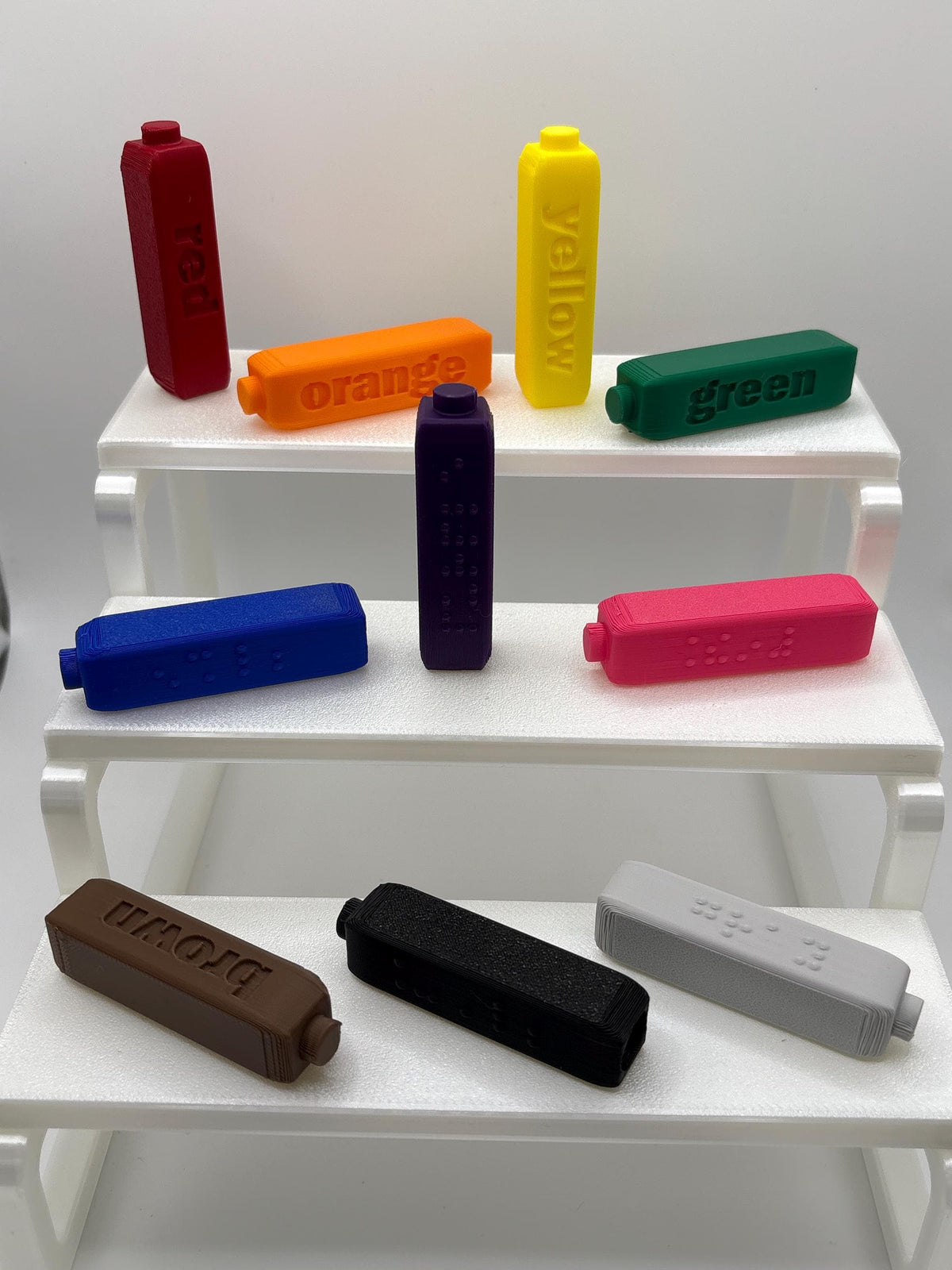 Braille toppers on Crayola Fine Line markers with built-in cap holders