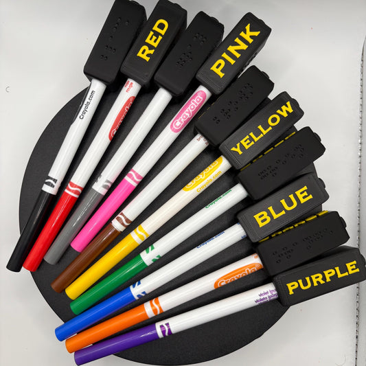 High contrast braille marker toppers with yellow large print on black, on Crayola Fine Line markers