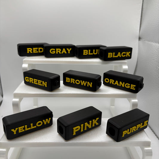 Set of 10 high contrast braille marker toppers, yellow on black